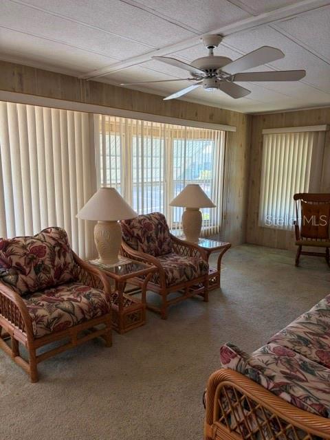 A living room features two wicker armchairs with floral cushions and a ceiling fan — 130 PATRICIA AVENUE UNIT 119, DUNEDIN, FL