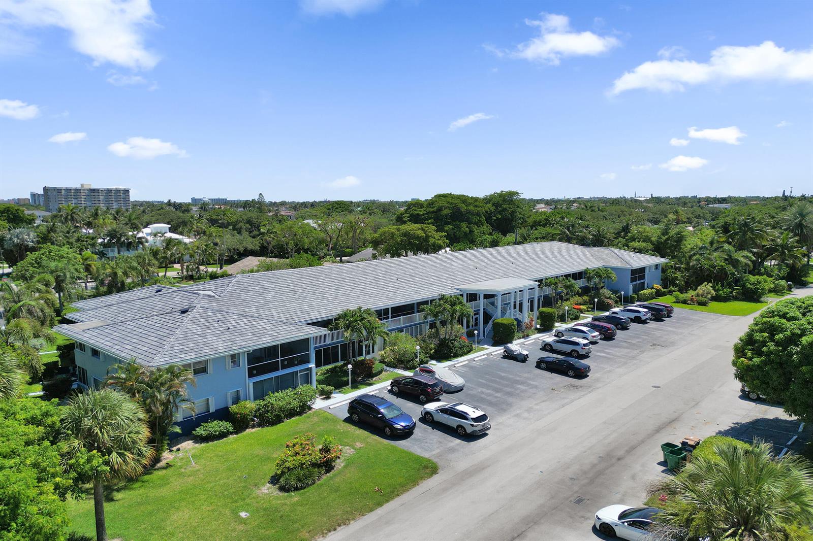An aerial view shows a multi-story apartment building with a gray roof and parking lot — 2734 NE 27th Court # 22, Lighthouse Point FL 33064, LIGHTHOUSE POINT, FL