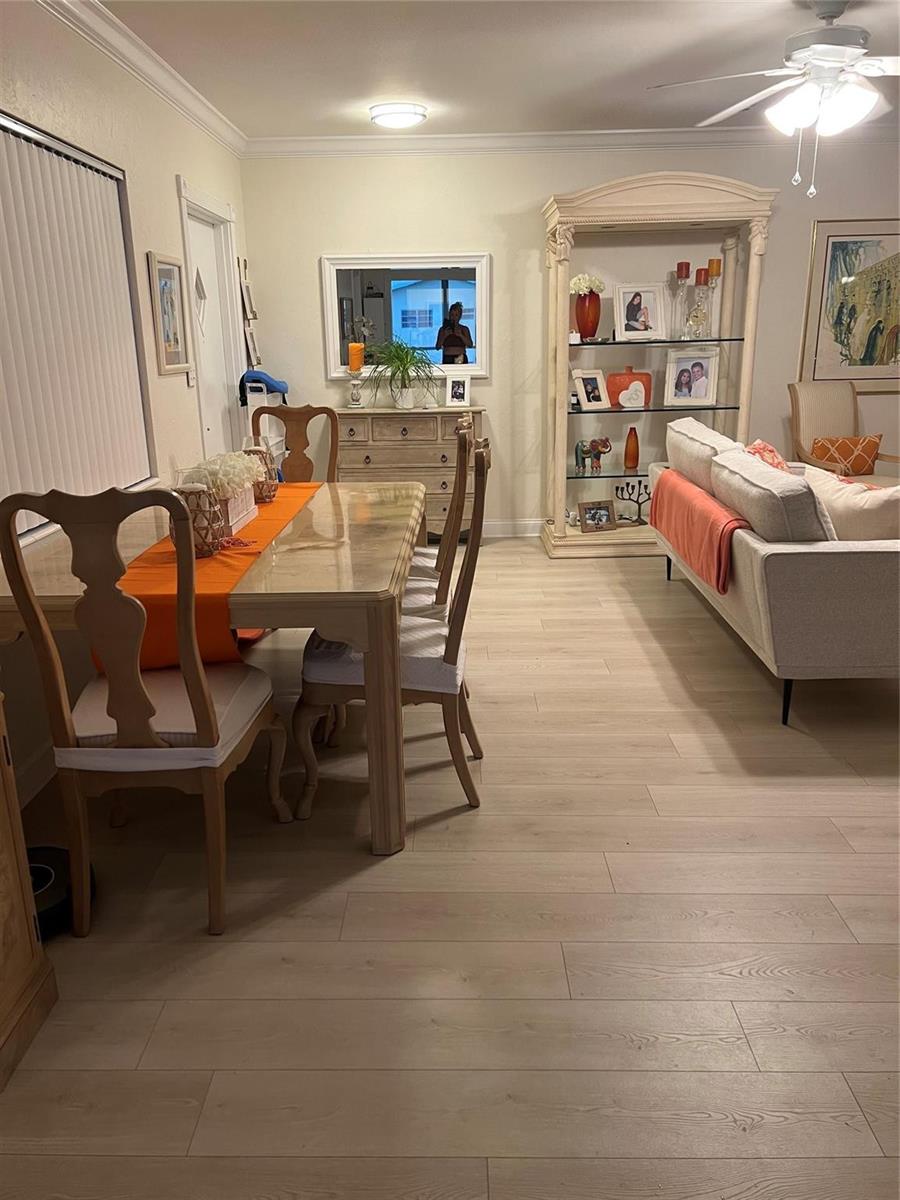 A dining area with a glass-top table and chairs adjacent to a living room space — 2734 NE 27th Court # 22, Lighthouse Point FL 33064, LIGHTHOUSE POINT, FL