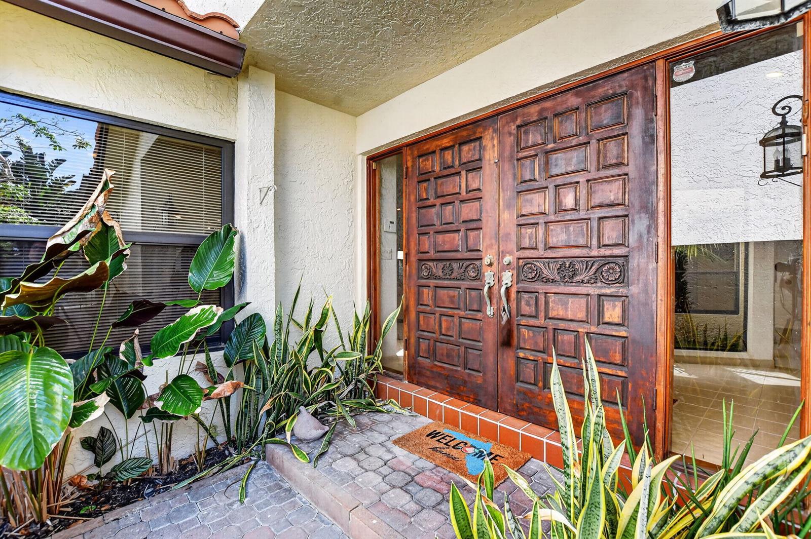 A front entrance features double wooden doors with carved panels and a brick porch — 22519 W Esplanada Cir W, Boca Raton FL 33433, BOCA RATON, FL