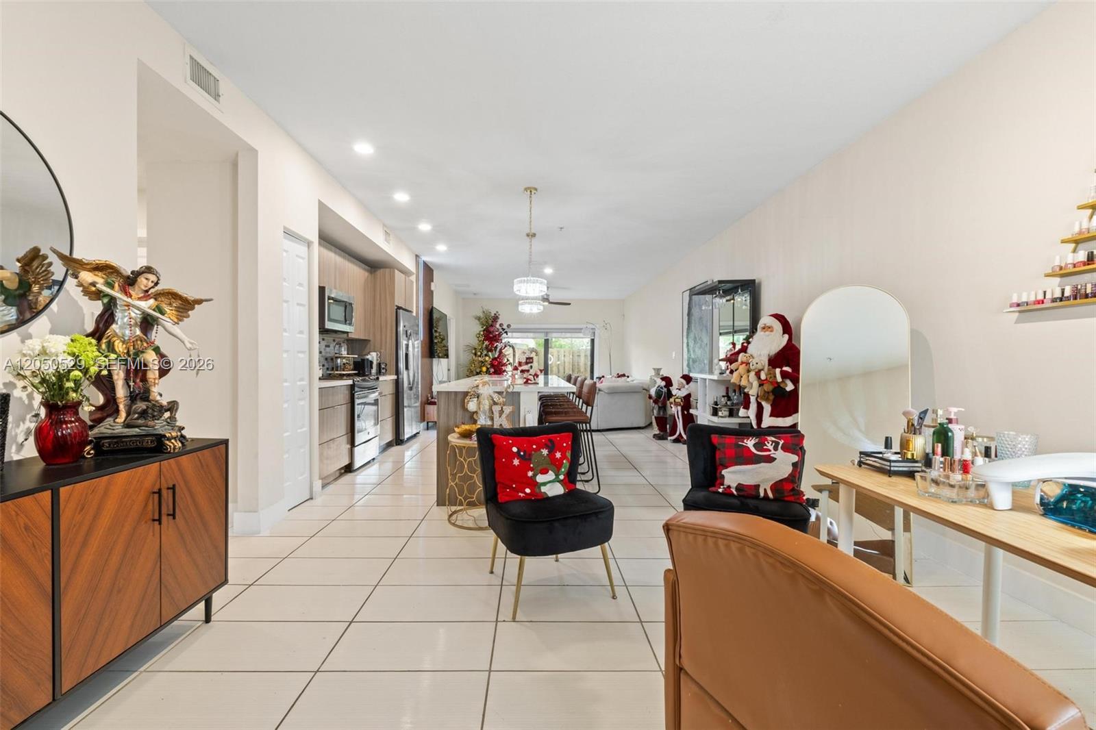 An open-concept living area features a kitchen, dining space, and a nail salon station — 7809 NW 104th Ave # 1, Doral FL 33178, DORAL, FL