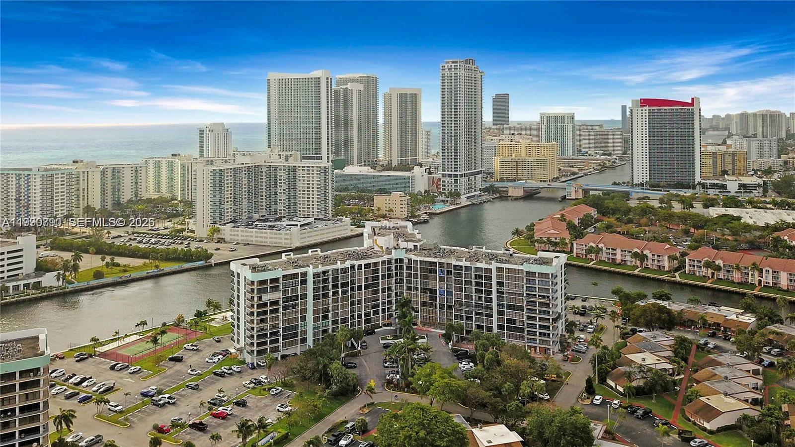 A dining area with a wooden table and chairs sits on a patterned rug — 200 Leslie Dr # 425, Hallandale Beach FL 33009, HALLANDALE BEACH, FL