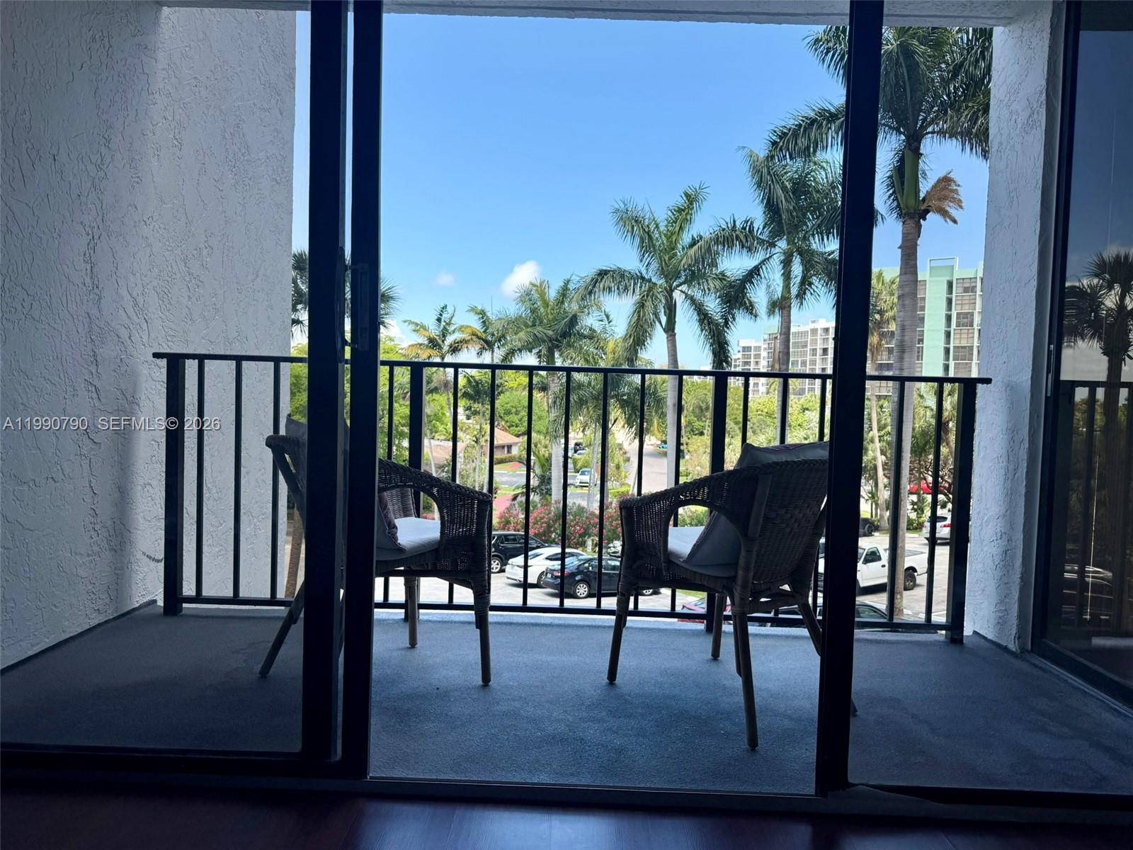 A living room features a beige sectional sofa, white coffee table, and wood-look flooring — 200 Leslie Dr # 425, Hallandale Beach FL 33009, HALLANDALE BEACH, FL