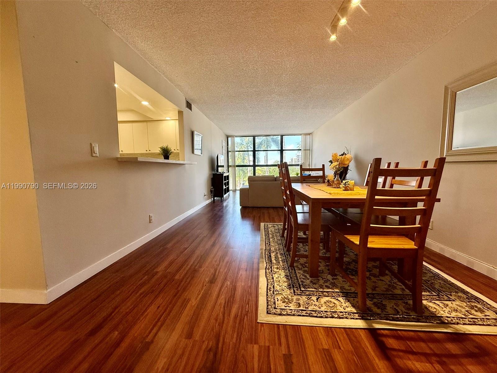 An aerial view shows a waterfront apartment complex with a pool and tennis court — 200 Leslie Dr # 425, Hallandale Beach FL 33009, HALLANDALE BEACH, FL