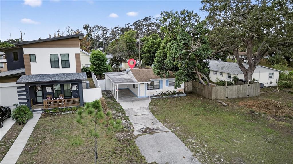 An aerial view shows a single-story house with a carport next to a modern two-story home — 2480 18TH AVENUE N, ST PETERSBURG, FL