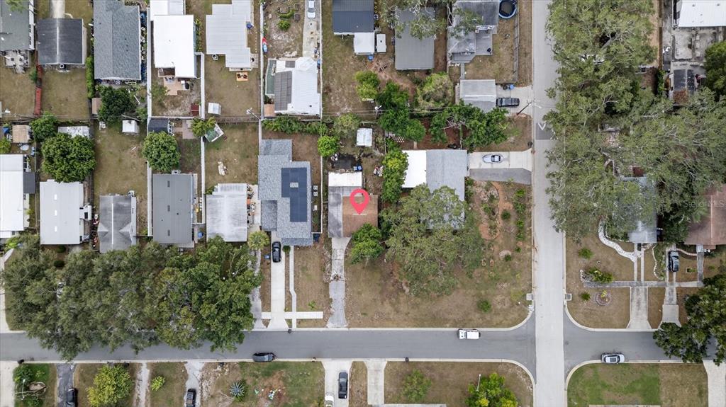 This aerial view shows a residential neighborhood with a red pin marking a specific house — 2480 18TH AVENUE N, ST PETERSBURG, FL