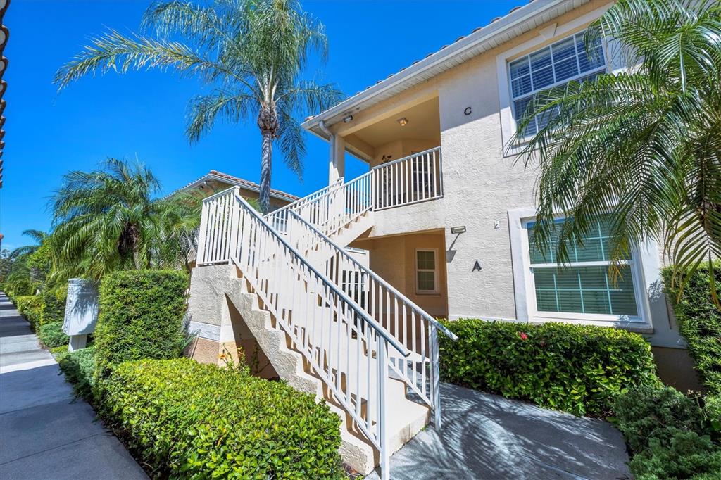 An aerial view shows several two-story residential buildings with tiled roofs and attached garages — 4206 VICENZA DRIVE UNIT C24, VENICE, FL