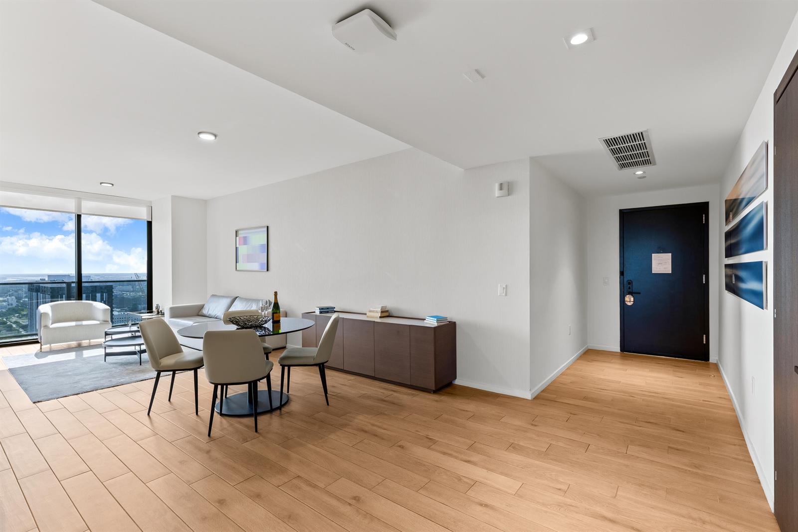 A modern living and dining area features light wood floors, a glass table, and floor-to-ceiling windows — 398 NE 5th Street # 4618, Miami FL 33132, MIAMI, FL