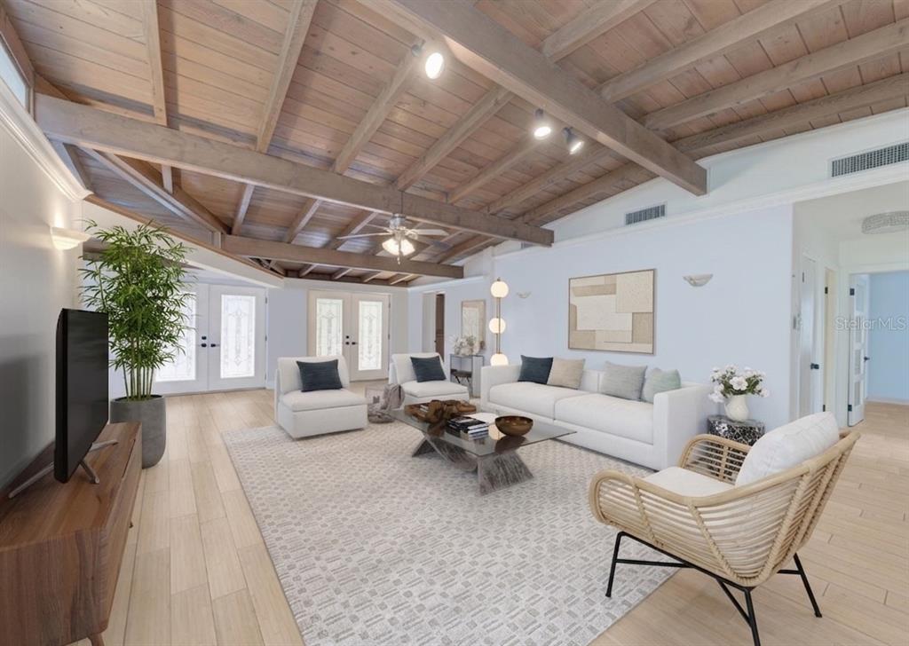 A living room features a vaulted wood-beam ceiling, white walls, and a light-colored area rug — 315 PARK BOULEVARD S, VENICE, FL