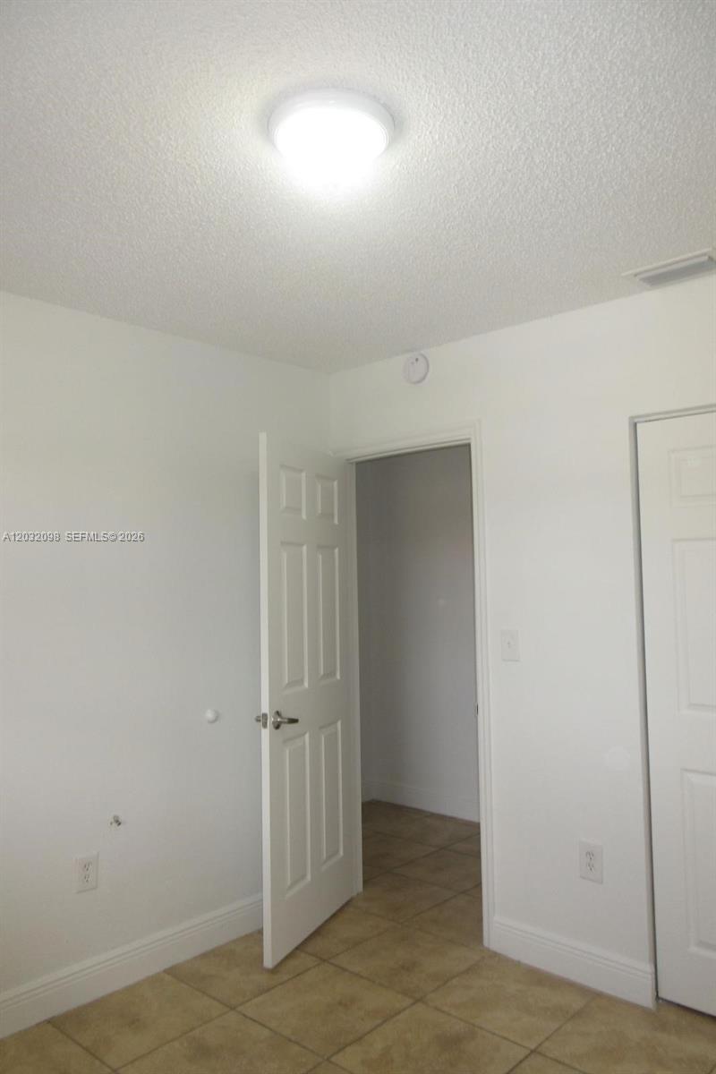 A room with white walls, a tiled floor, and an open doorway — 5461 W 24th Ave # 67, Hialeah FL 33016, HIALEAH, FL