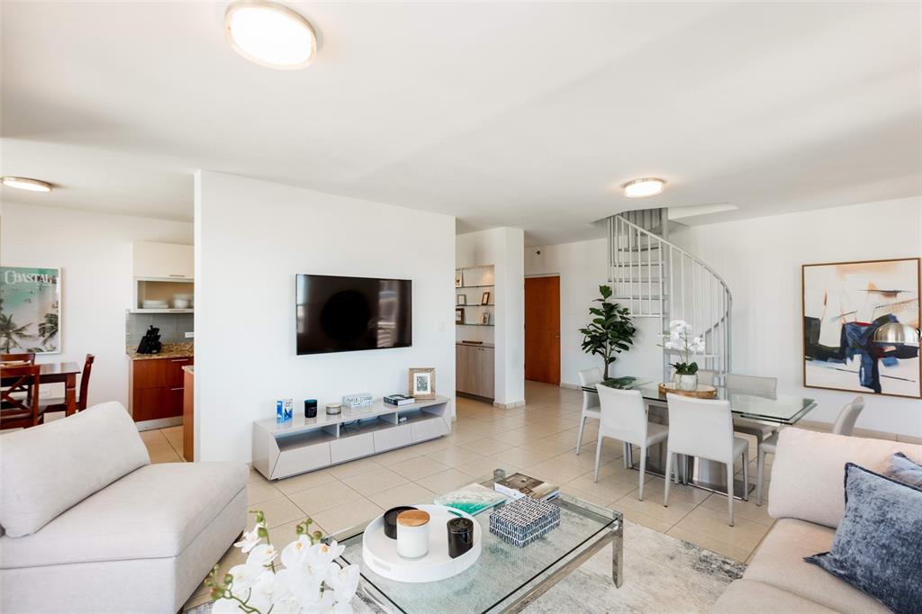 A living and dining area features a spiral staircase, tile flooring, and modern furniture — Cond Capitolio Plaza CALLE DEL MUELLE UNIT 21007, SAN JUAN, PR