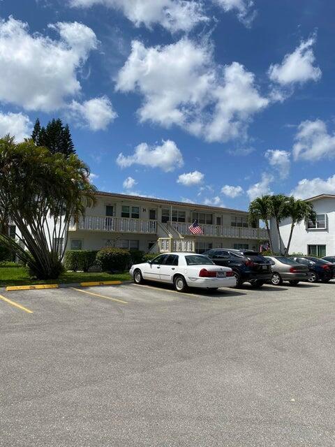 A white two-story apartment building with a parking lot in the foreground — 190 Easthampton H, West Palm Beach FL 33417, WEST PALM BEACH, FL