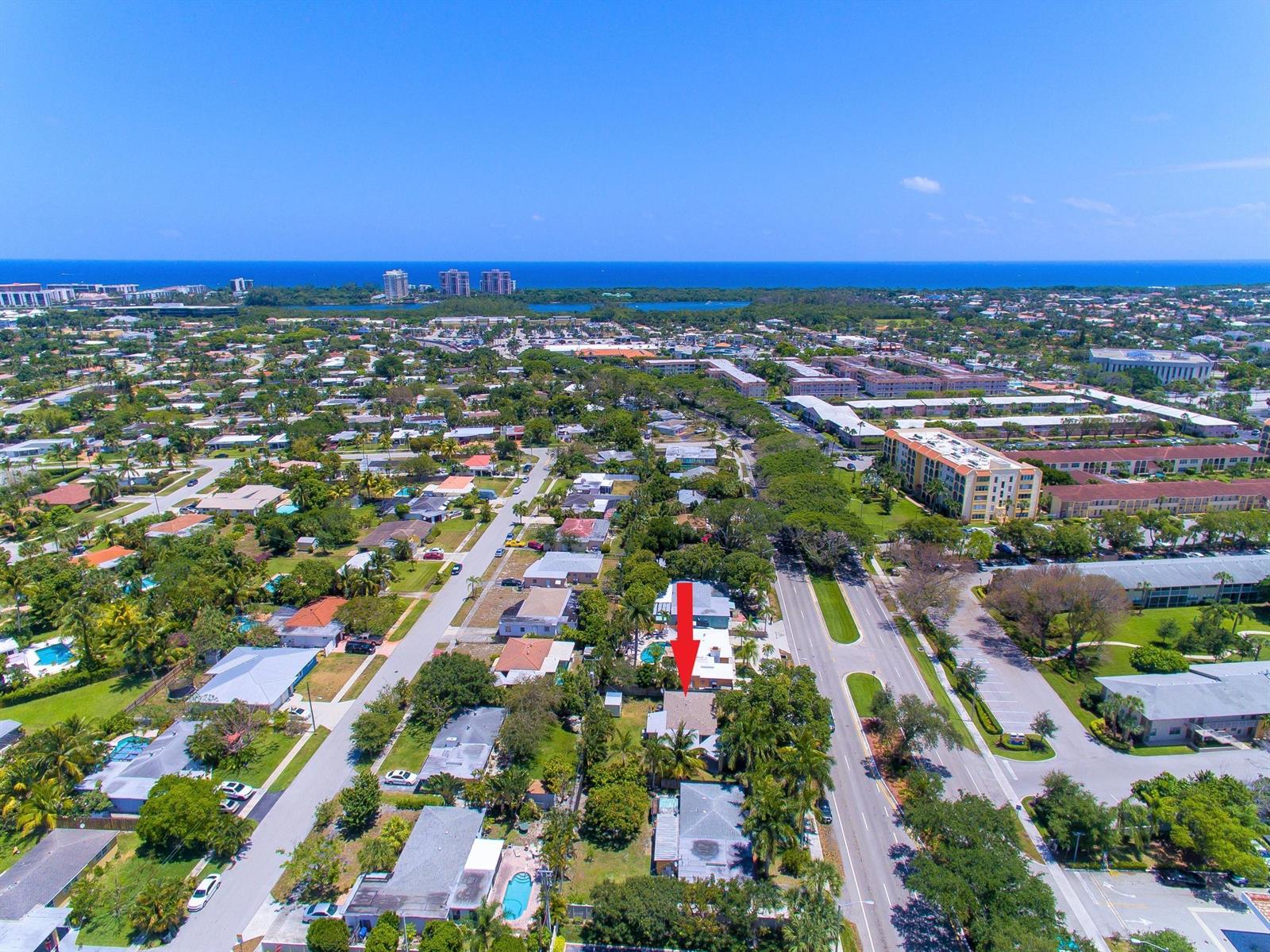 An aerial view shows a residential neighborhood with a red arrow pointing to a house — 155 NE 20th Street, Boca Raton FL 33431, BOCA RATON, FL