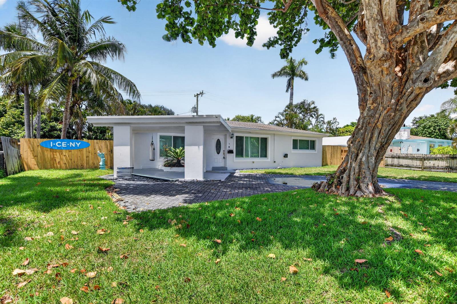 A white single-story house with a covered porch and a large tree in the yard — 155 NE 20th Street, Boca Raton FL 33431, BOCA RATON, FL