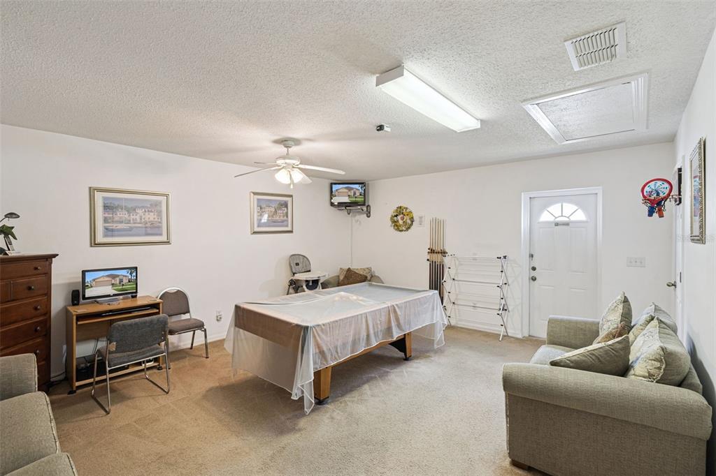 A carpeted recreation room features a pool table, a computer desk, and a sofa — 170 BLOOMINGDALE DRIVE, DAVENPORT, FL