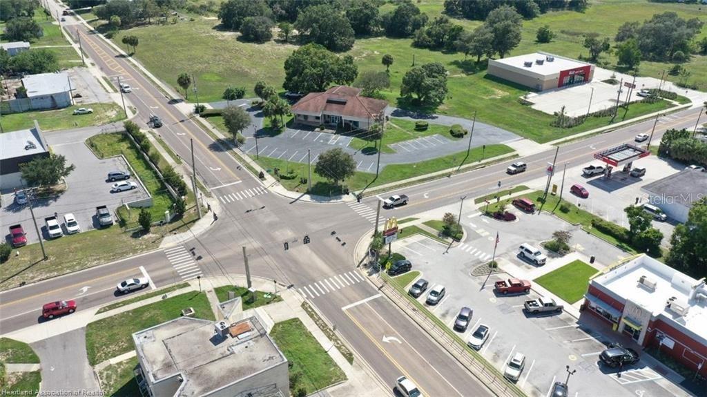 An aerial view shows a commercial intersection with a McDonald's, parking lots, and surrounding roads — 695 N SCENIC HIGHWAY, FROSTPROOF, FL