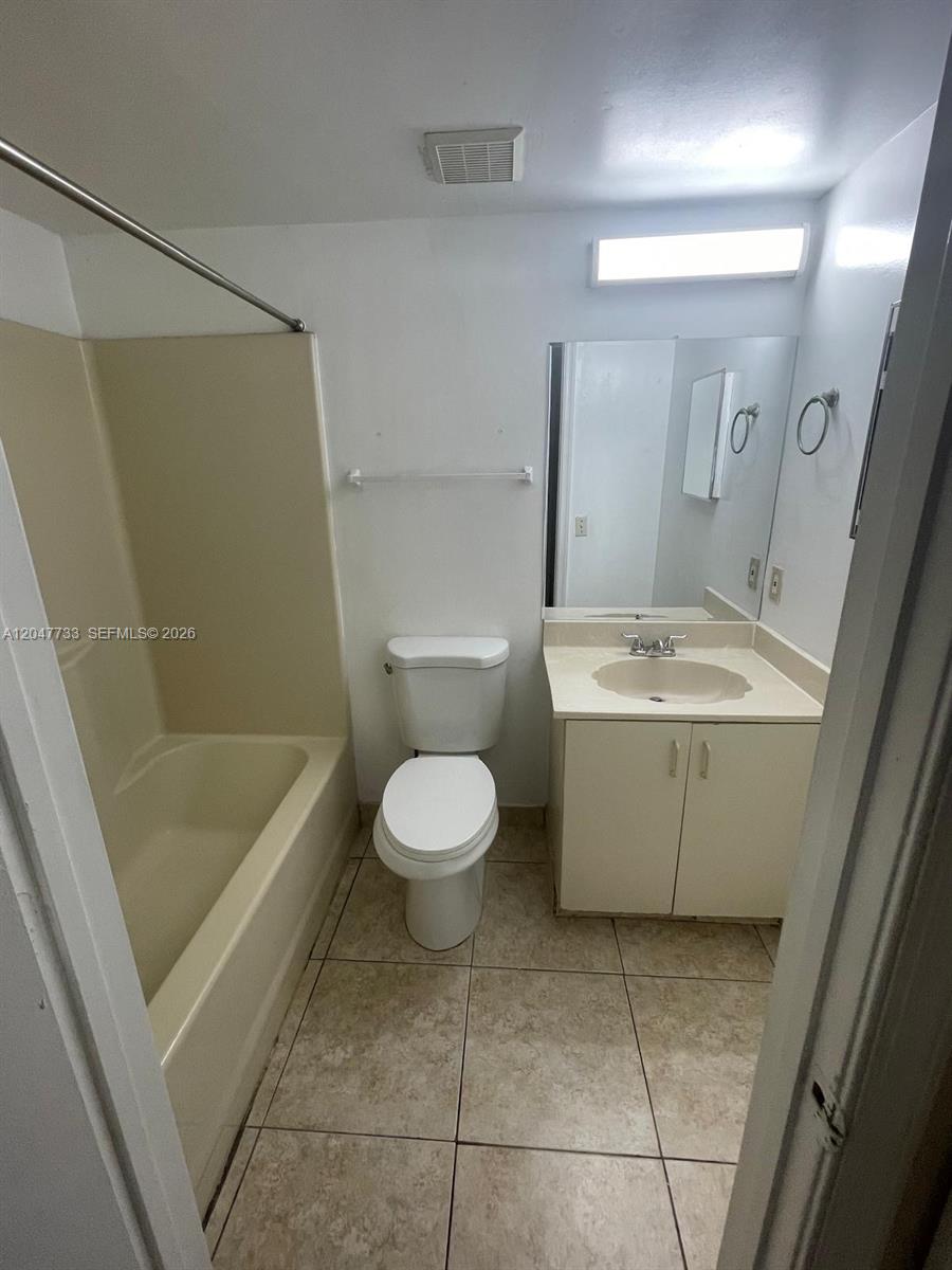 A bathroom features a beige tub-shower combo, a white toilet, and a vanity with sink — 3660 N 56th Ave # 601, Hollywood FL 33021, HOLLYWOOD, FL