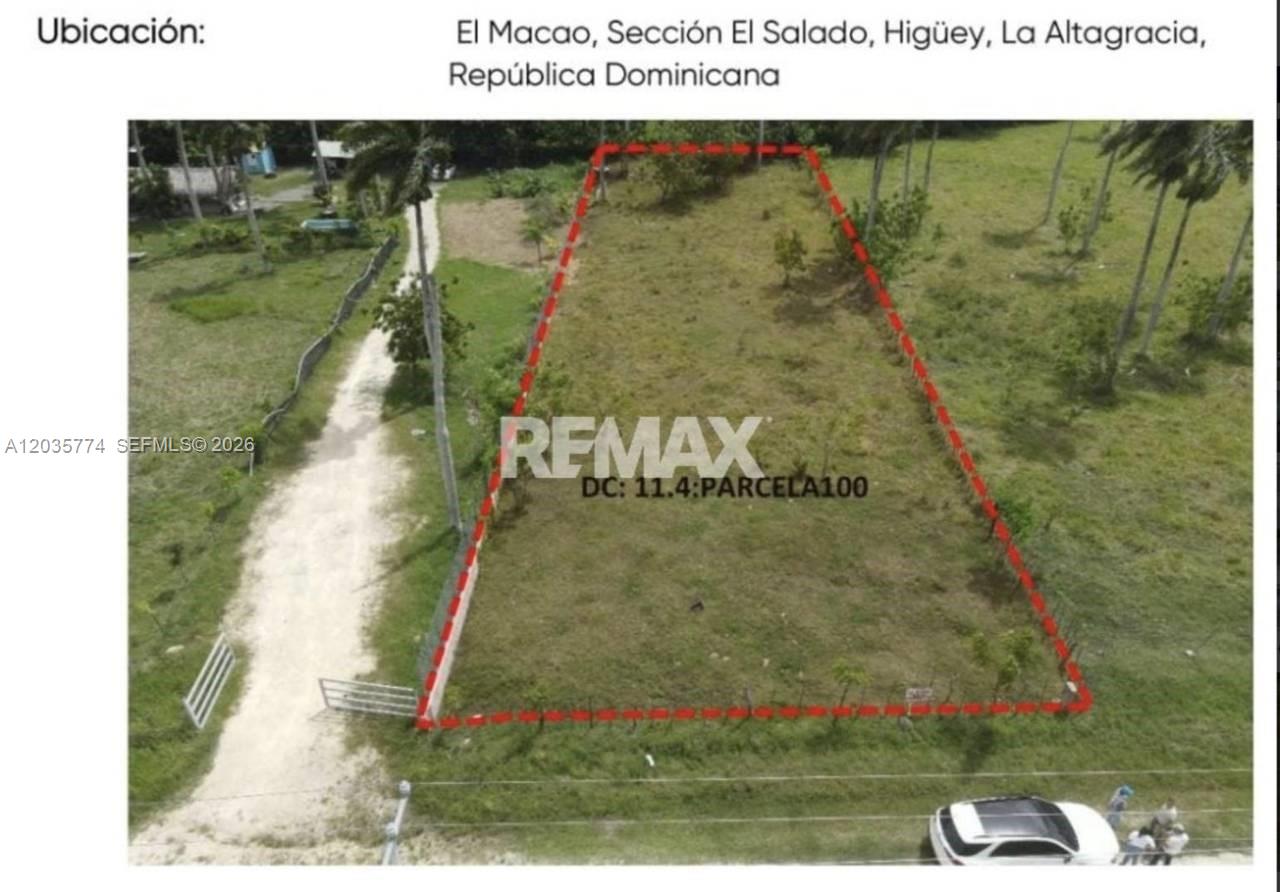 An aerial view shows a rectangular plot of land outlined in red near a road — macao, FL