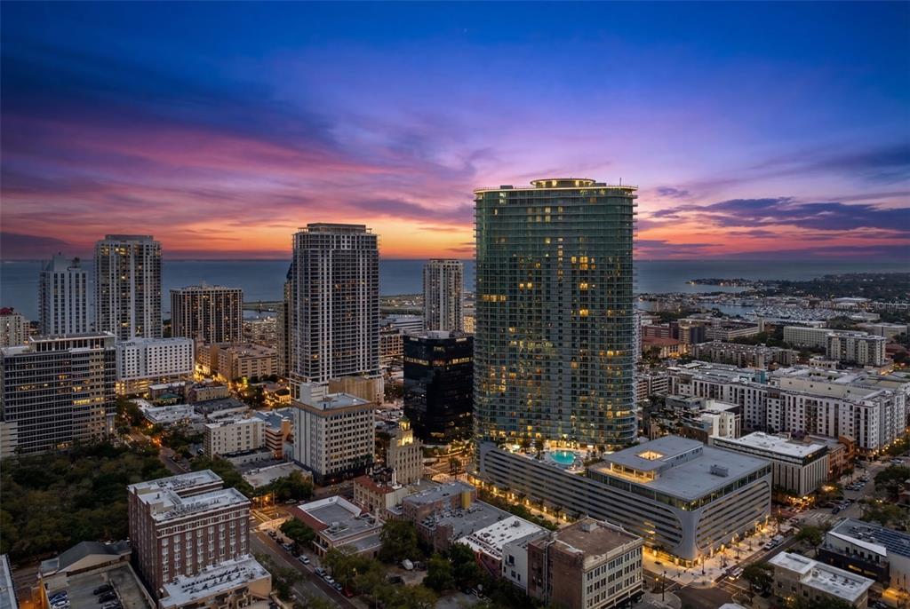 An aerial view of a city skyline at sunset featuring high-rise buildings and a waterfront — 400 CENTRAL AVENUE UNIT 1405, ST PETERSBURG, FL