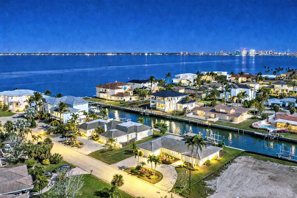 An aerial view of a waterfront neighborhood at night with houses along a canal — 548 GUNWALE LANE, LONGBOAT KEY, FL
