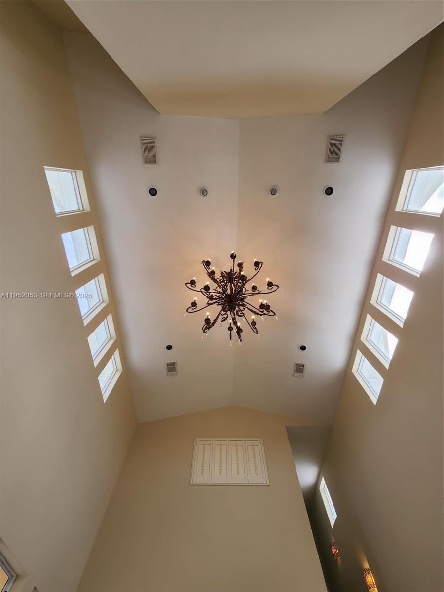 A high-ceilinged room features a large chandelier and multiple windows along the angled walls — 3601 N Highway A1a, Fort Pierce FL 34949, FORT PIERCE, FL