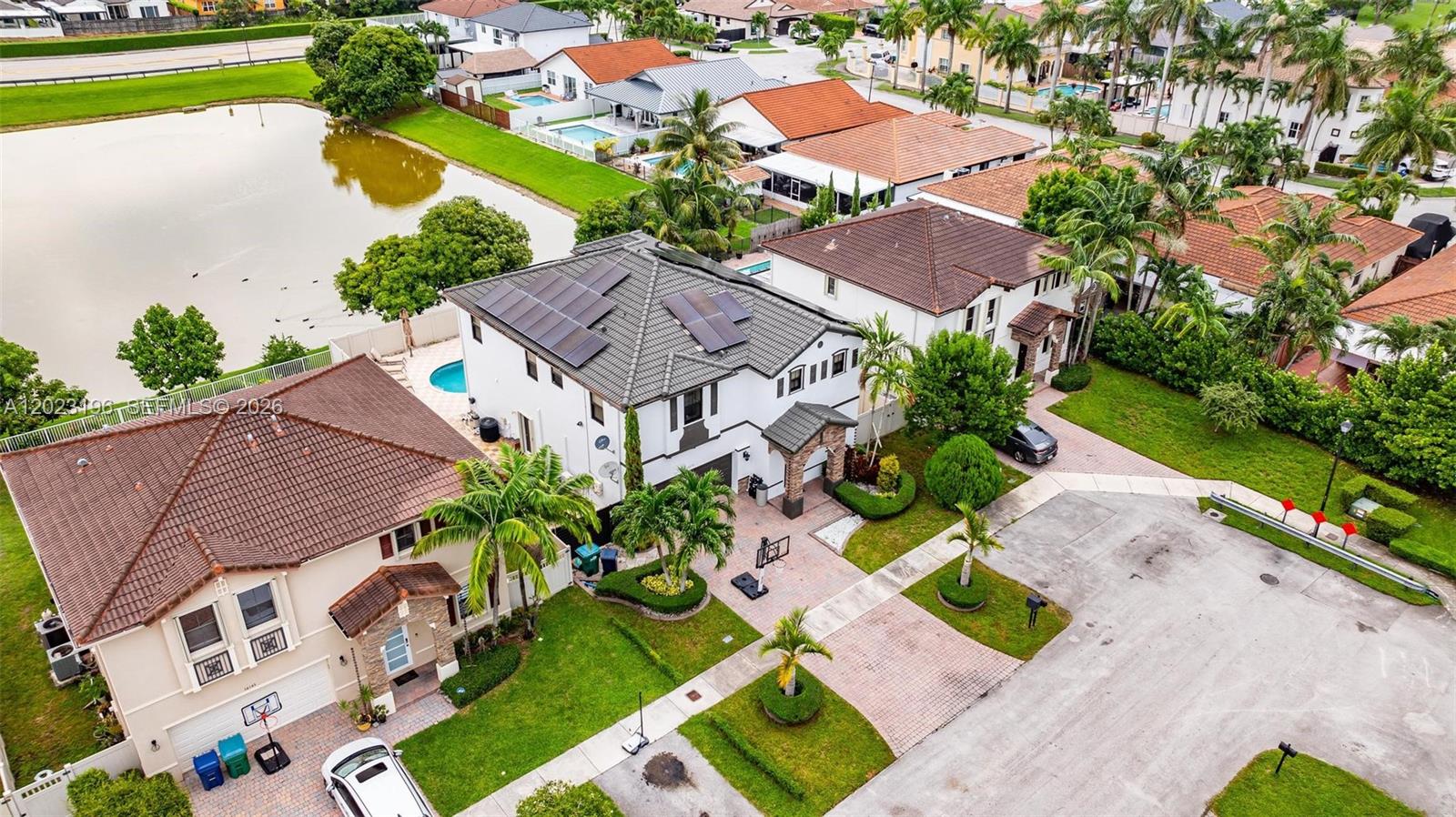 An aerial view shows two-story suburban houses with tile roofs, pools, and paved driveways — 16125 SW 65th Ln, Miami FL 33193, MIAMI, FL