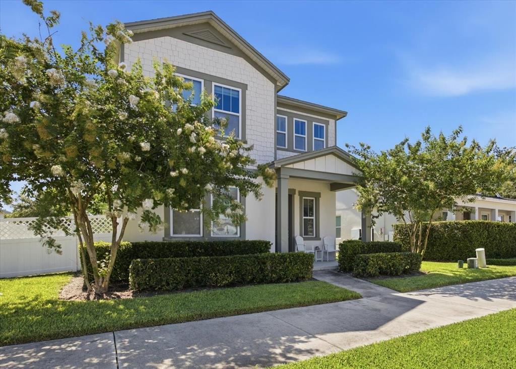 A two-story house with white siding, a covered front porch, and manicured hedges — 6323 HAMLIN RESERVE BOULEVARD, WINTER GARDEN, FL