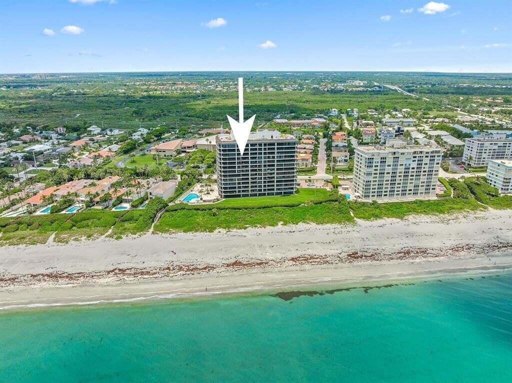 An aerial view of a beachfront high-rise condominium building on a sunny day — 800 Ocean Drive # 1104, Juno Beach FL 33408, JUNO BEACH, FL
