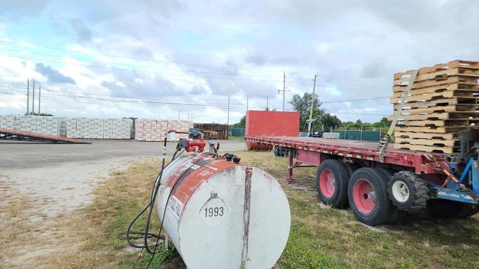 A fuel tank sits in a gravel yard next to a flatbed trailer carrying wooden pallets — 0 S S. State Road, Boynton Beach FL 33472, BOYNTON BEACH, FL