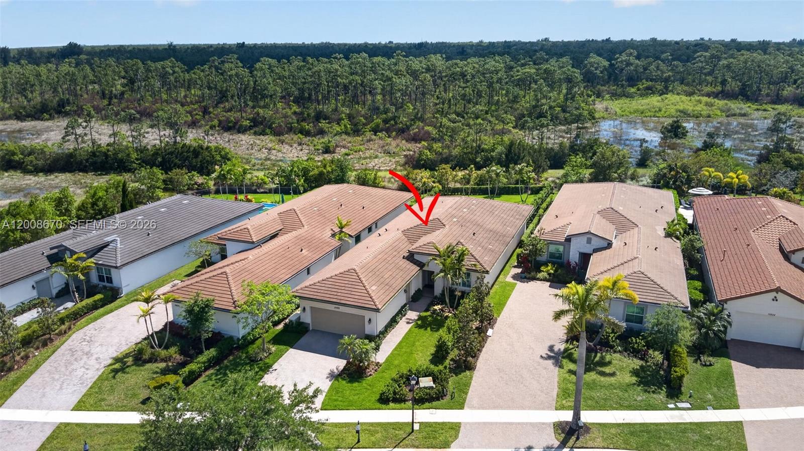 An aerial view shows a suburban house with a tiled roof and a red arrow — 10626 Starling Way, West Palm Beach FL 33412, WEST PALM BEACH, FL