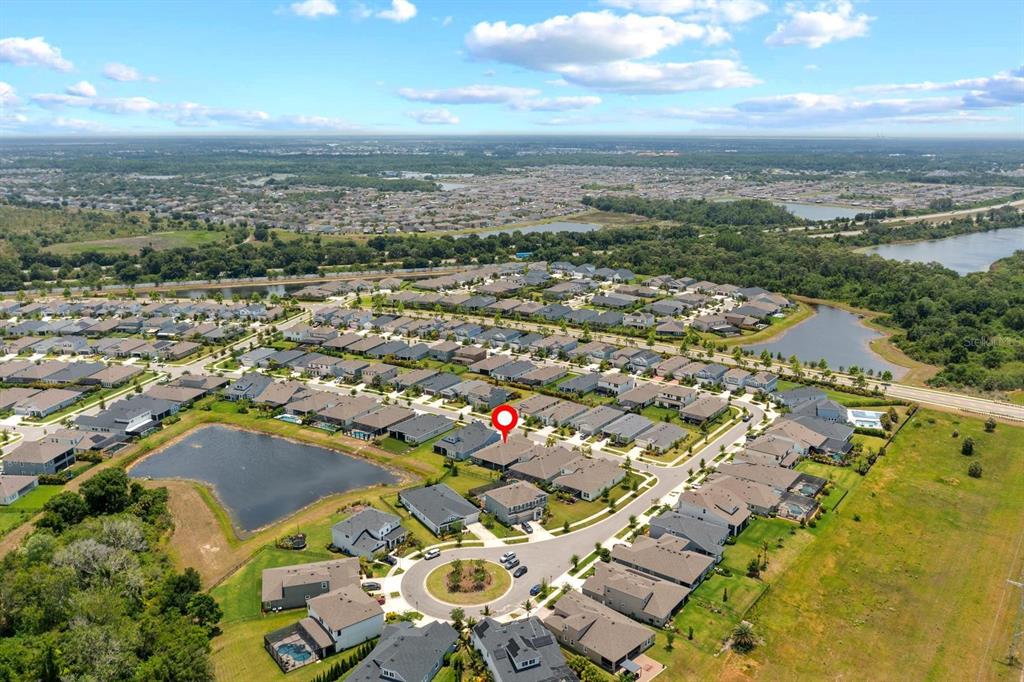 An aerial view shows a residential neighborhood with houses, a pond, and a red location marker — 5406 LIMELIGHT DRIVE, APOLLO BEACH, FL