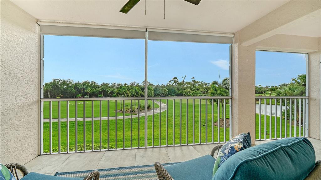 A screened-in balcony overlooks a green golf course with a paved path and trees — 9320 CLUBSIDE CIRCLE UNIT 2205, SARASOTA, FL