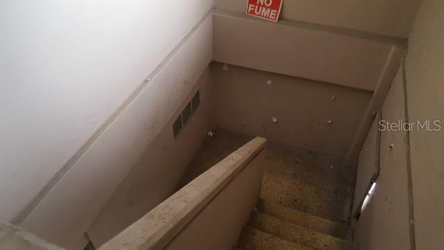 A view looking down a concrete stairwell with a handrail and a no smoking sign — GAUTIER BENITEZ ST. INT. INT. JIMENEZ SICARDO ST., CAGUAS, PR