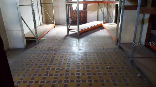 An interior room features metal shelving units and patterned tile flooring — GAUTIER BENITEZ ST. INT. INT. JIMENEZ SICARDO ST., CAGUAS, PR