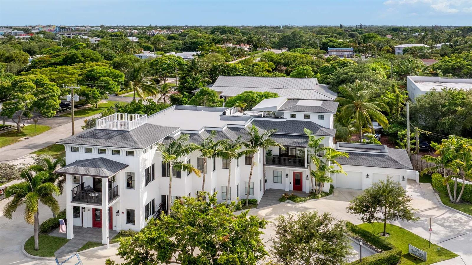 An aerial view of a large white multi-story house with a grey roof and palm trees — 230 George Bush Boulevard, Delray Beach FL 33444, DELRAY BEACH, FL
