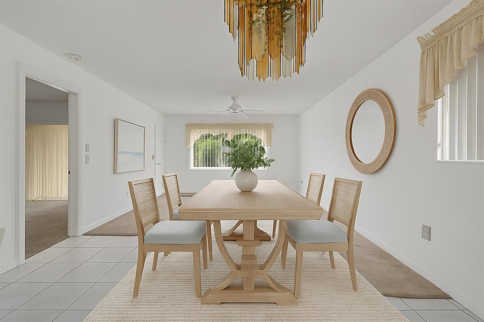 A dining room features a light wood table, four chairs, a chandelier, and a mirror — 6670 Royal Palm Boulevard # 314k, Margate FL 33063, MARGATE, FL