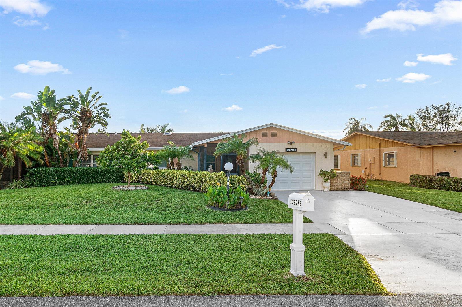 A single-story house with a white garage, a green lawn, and a mailbox in front — 13297b Vía Vulcanus, Delray Beach FL 33484, DELRAY BEACH, FL