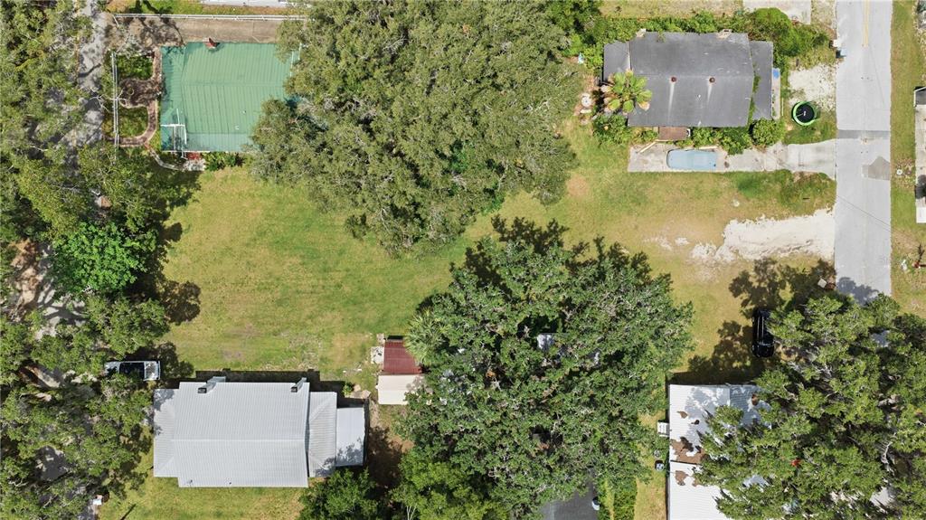 An aerial view shows a residential lot with two houses, large trees, and a driveway — 1 CENTRAL WAREHOUSE, OCALA, FL