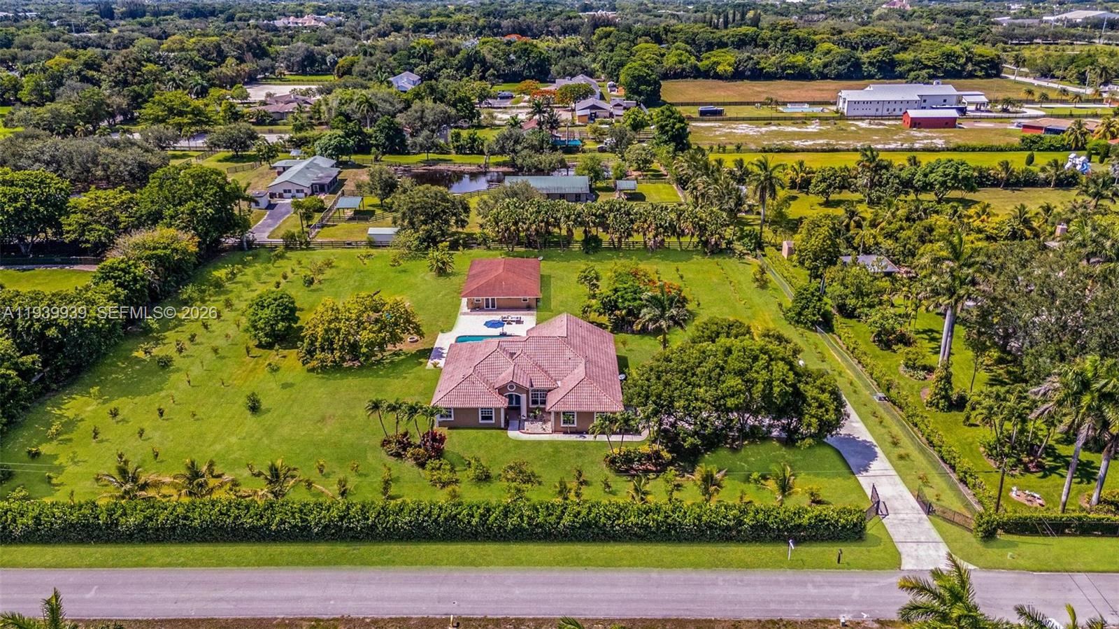 An aerial view shows a house with a tiled roof, a pool, and a detached building — 12851 Luray Rd, Southwest Ranches FL 33330, SOUTHWEST RANCHES, FL