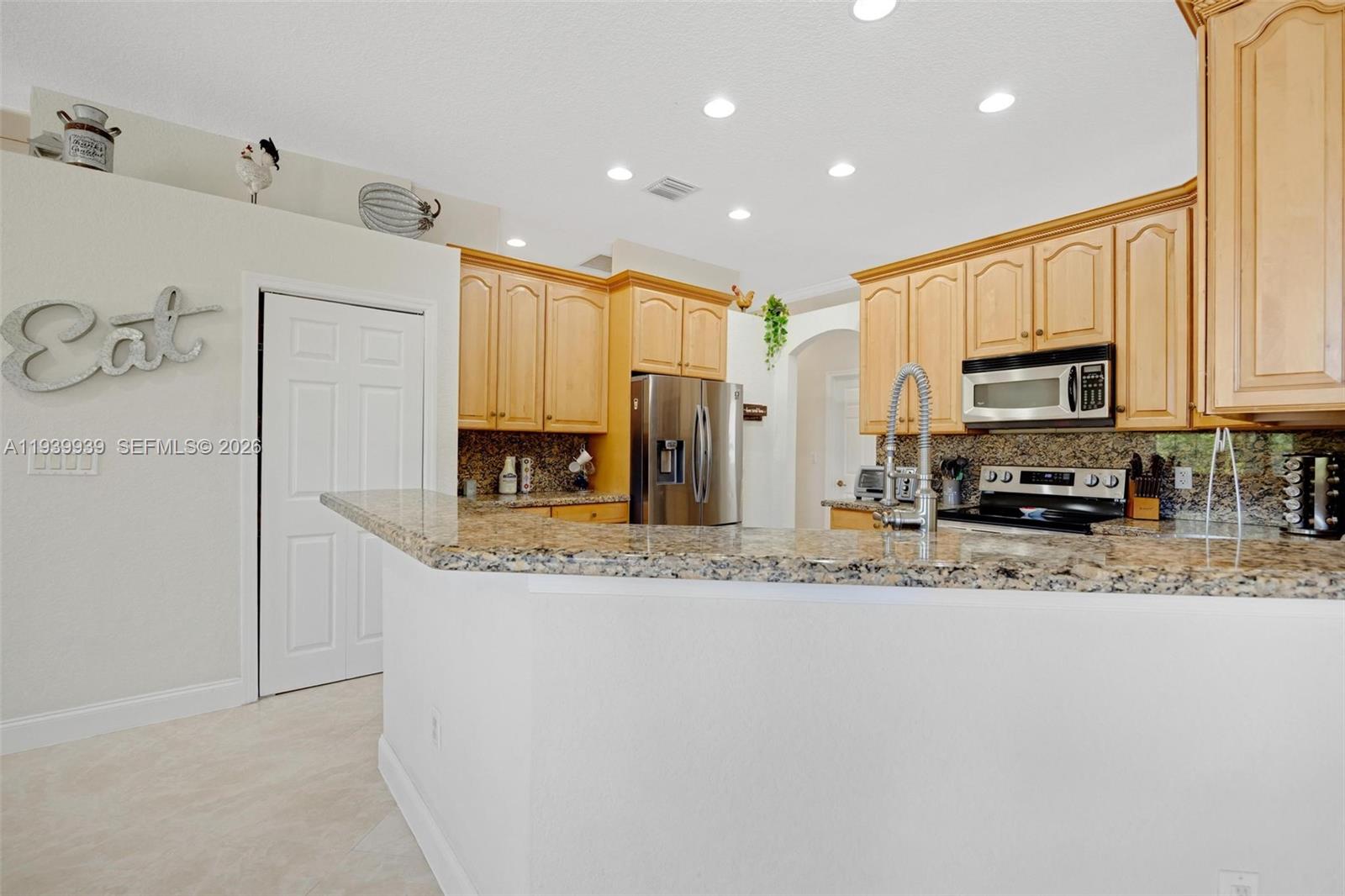 A game room features a purple pool table, a crystal chandelier, and an arched window — 12851 Luray Rd, Southwest Ranches FL 33330, SOUTHWEST RANCHES, FL