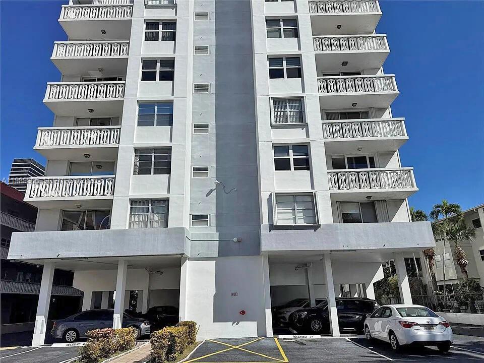 A multi-story white apartment building with balconies and ground-level covered parking — 3113 S Ocean Dr # 504, Hallandale Beach FL 33009, HALLANDALE BEACH, FL