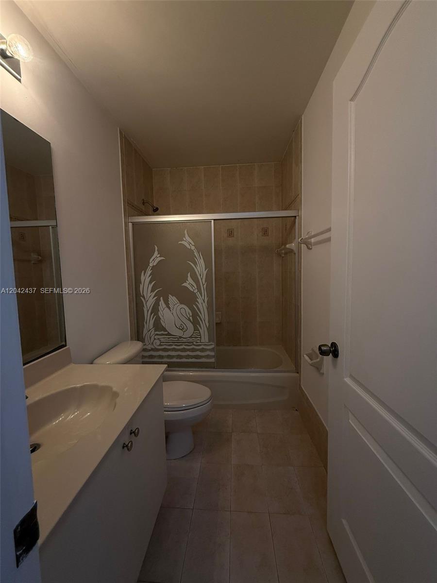 A bathroom features a vanity with a sink, a toilet, and a shower-tub combination — 17640 NW 73rd Ave # 19, Hialeah FL 33015, HIALEAH, FL