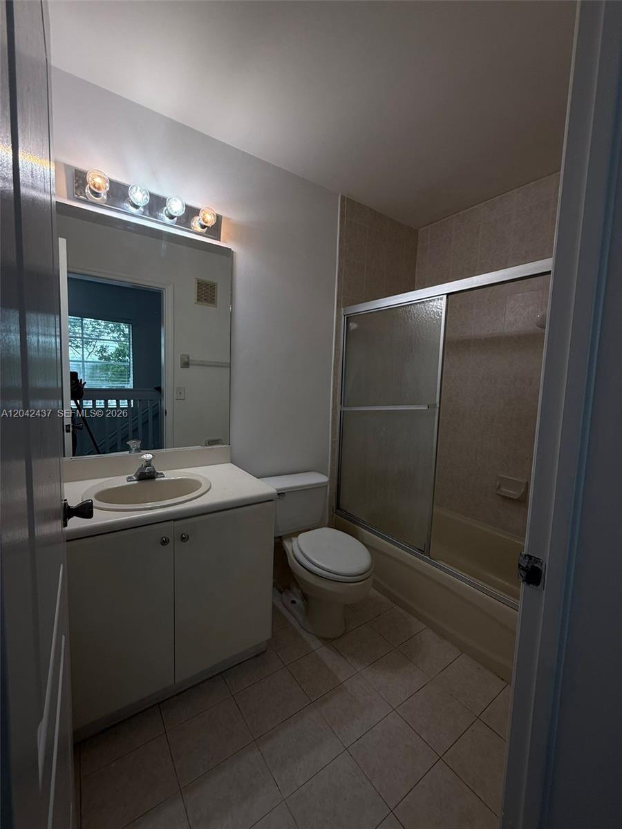 A bathroom features a vanity with a sink, a toilet, and a shower-tub combination — 17640 NW 73rd Ave # 19, Hialeah FL 33015, HIALEAH, FL