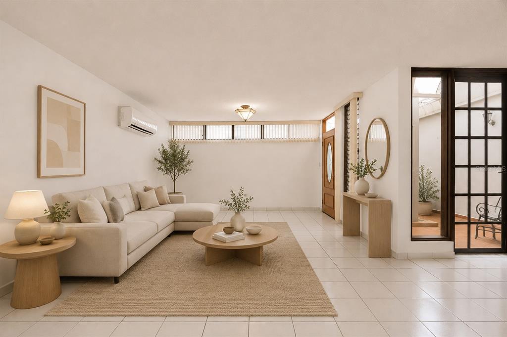 A bright living room features a beige sectional sofa, a round coffee table, and tile flooring — B-14 CALLE SEVILLA BILTMORE, GUAYNABO, PR