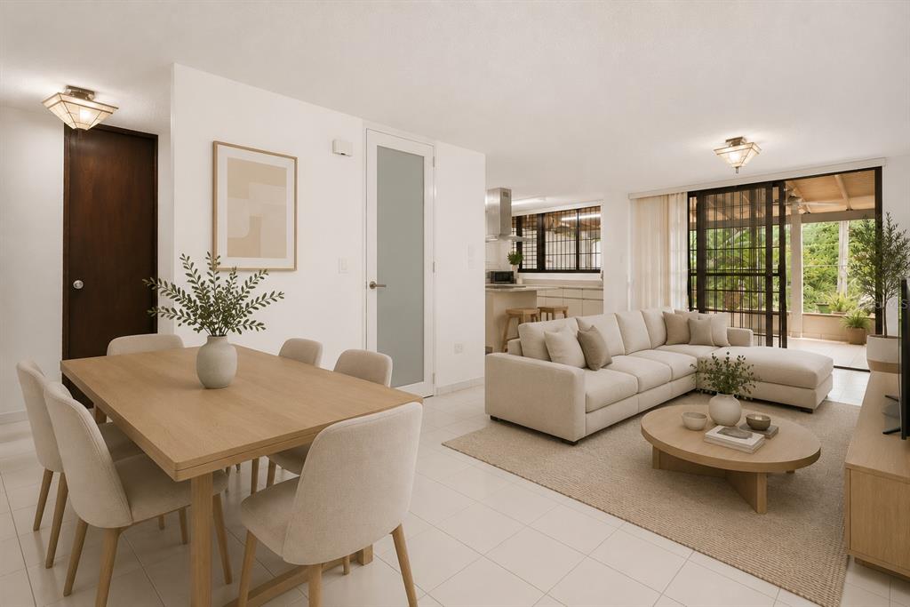 An open-concept living and dining area features light wood furniture, a beige sectional, and tile floors — B-14 CALLE SEVILLA BILTMORE, GUAYNABO, PR