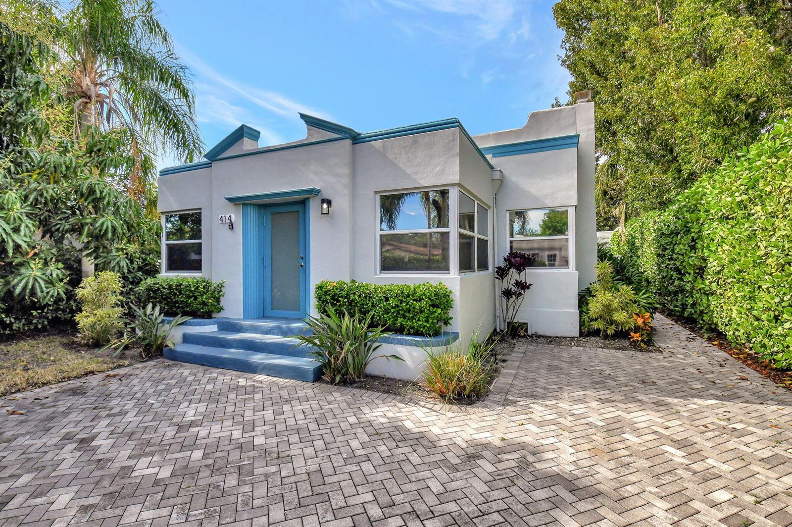 A light gray Art Deco style house with blue trim and a brick paver driveway — 414 NE 7th Avenue, Delray Beach FL 33483, DELRAY BEACH, FL