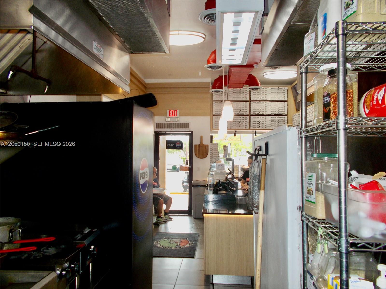 A commercial kitchen and service counter area with metal shelving and a Pepsi refrigerator — 8237 SW 124th St, Pinecrest FL 33156, PINECREST, FL