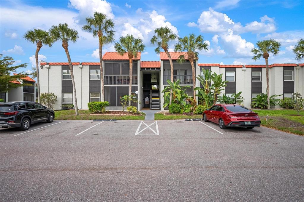 A two-story apartment building with a parking lot in front and palm trees — 3223 BENEVA ROAD UNIT 101, SARASOTA, FL