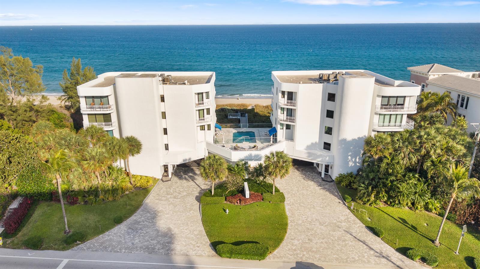 An aerial view shows a white multi-story beachfront condominium building with a central swimming pool — 2150 N Ocean Blvd, Boca Raton FL 33431, BOCA RATON, FL