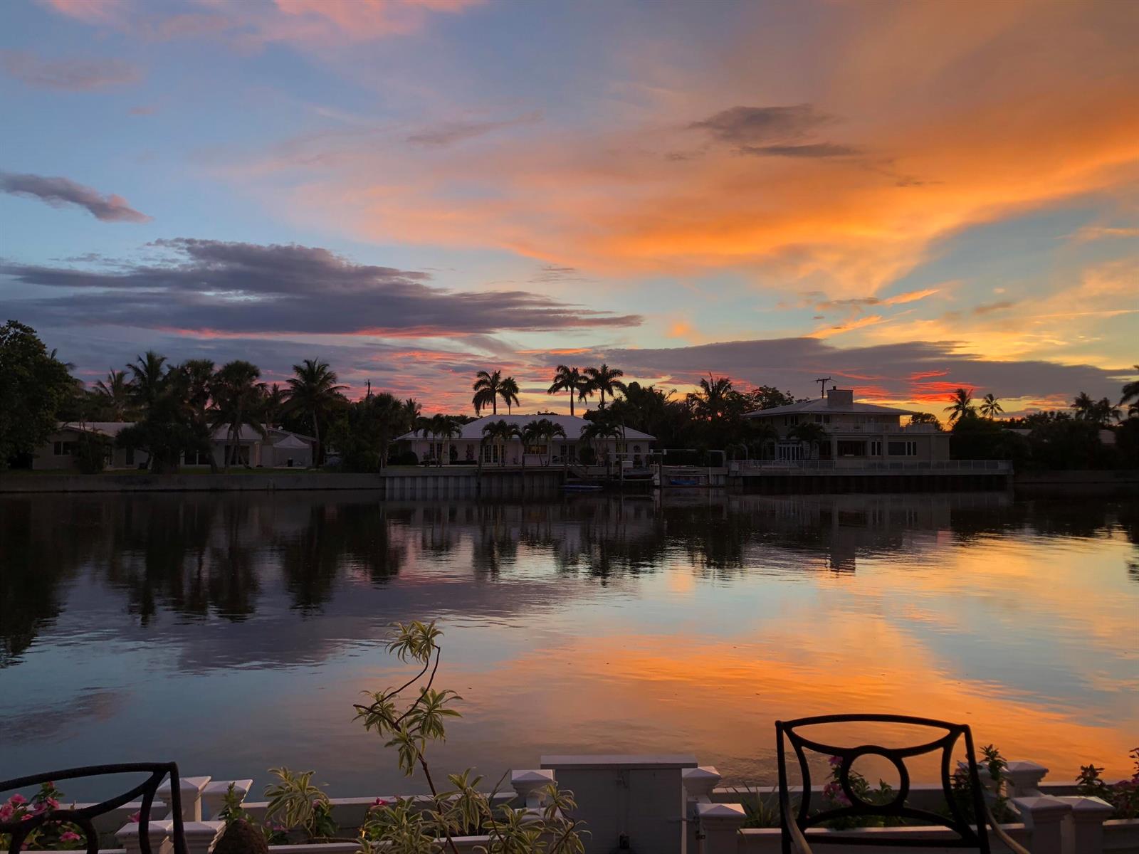 A sunset view over a calm canal with waterfront houses and palm trees in the background — 2272 S Ocean Boulevard # T6, Palm Beach FL 33480, PALM BEACH, FL